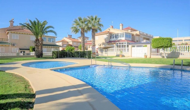 Spacious ground floor apartment overlooking the beautiful communal pool